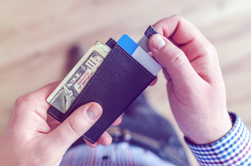 Person holding black card holder.