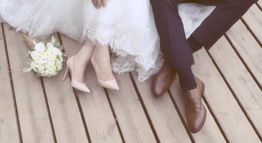 Feet of bride and groom, wedding shoes.