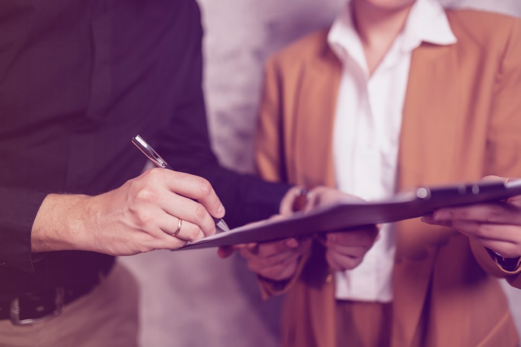 A Person signing a document.