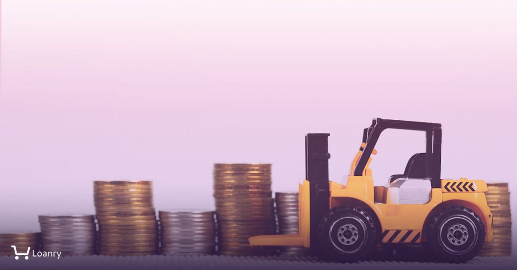Toy forklift picking up coins