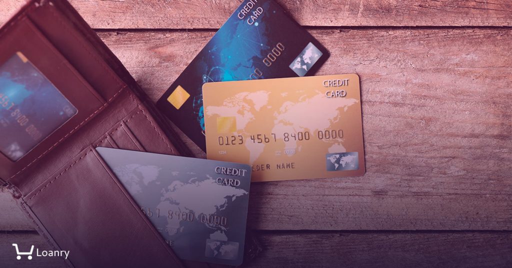 Credit cards in leather wallet on wooden background