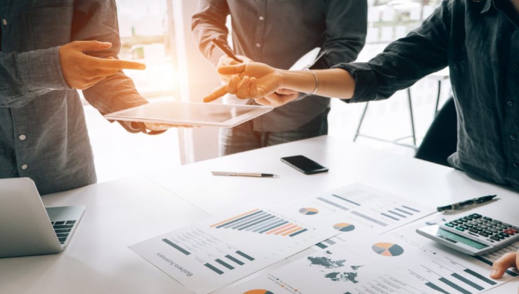 Business people analyzing investment graph