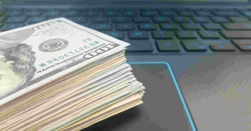 Close up portrait a pile of money on computer keyboard