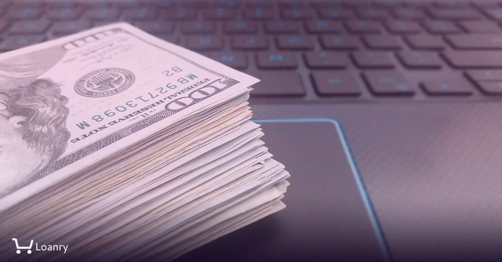 Close up portrait a pile of money on computer keyboard.