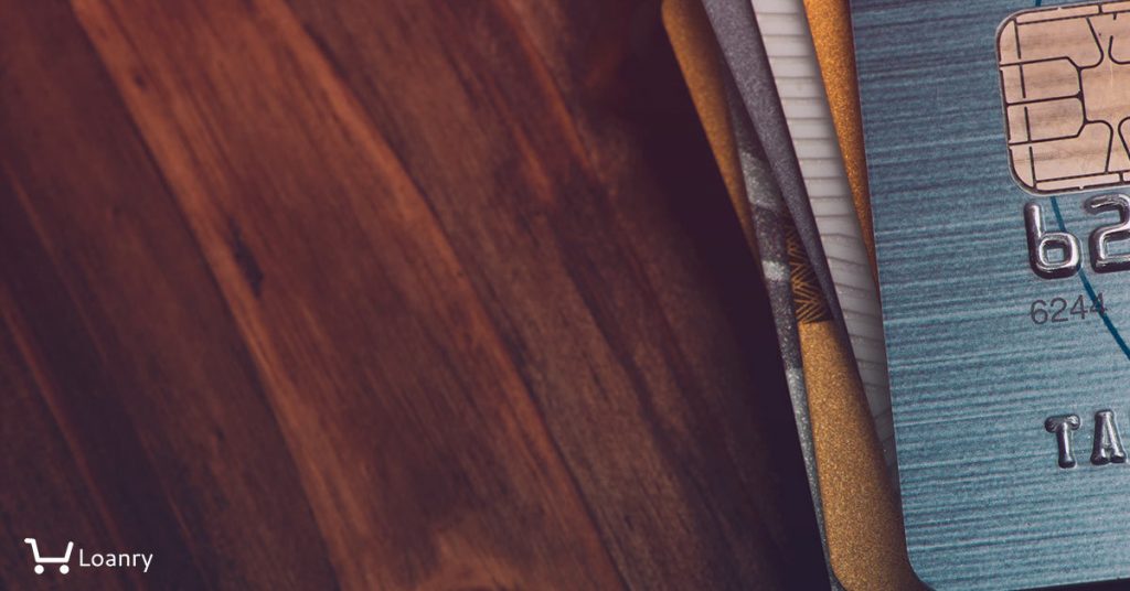 Stack of multicolored credit cards close-up.