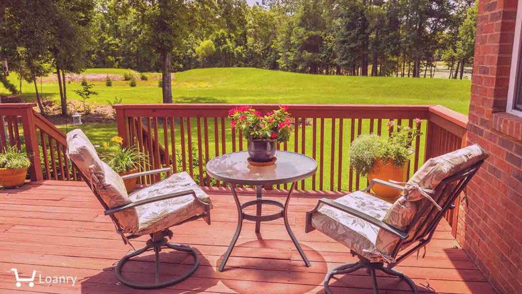 Backyard deck overlooking lake outside residential structure