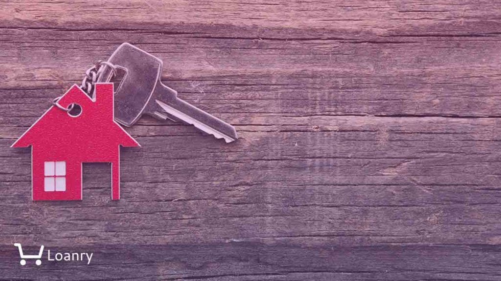 Symbol of the house with silver key on vintage wooden background.