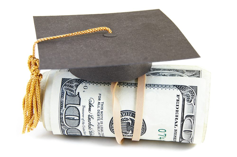 Mini graduation cap on rolled up cash